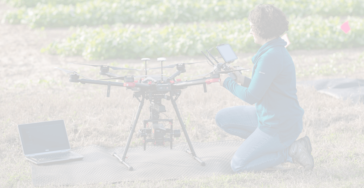 girl in field with drone