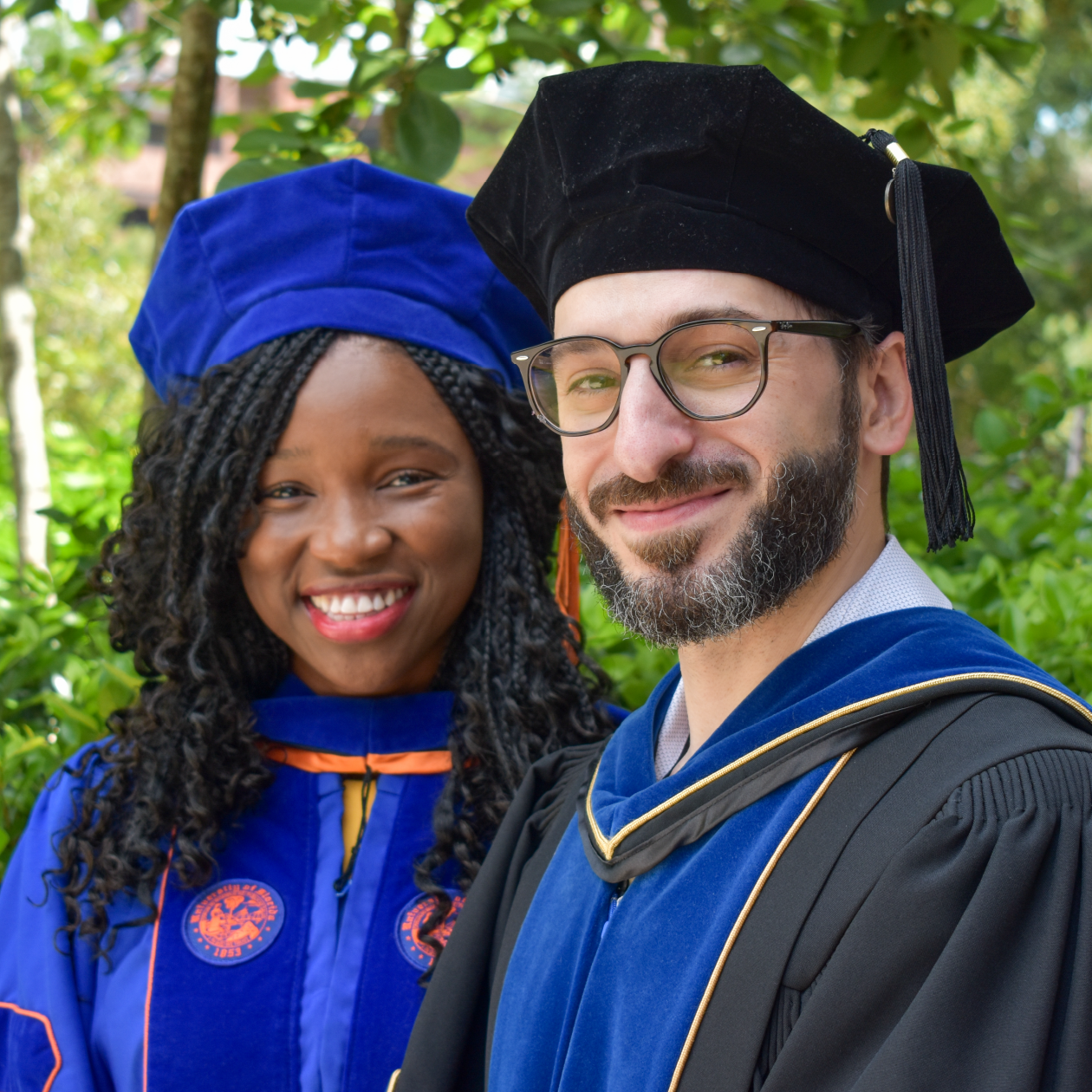 Ph.D. student and advisor wearing graduation regalia